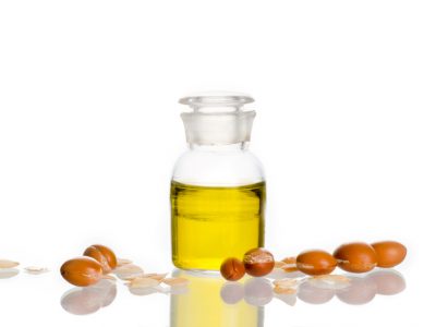 Argan oil with fruits on white background. Argan comes from Morocco and is used in cosmetic products